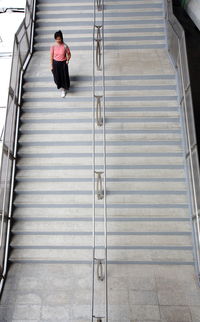 High angle view of woman moving down on staircase