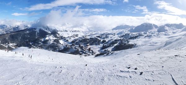 Scenic view of snow covered mountains against sky