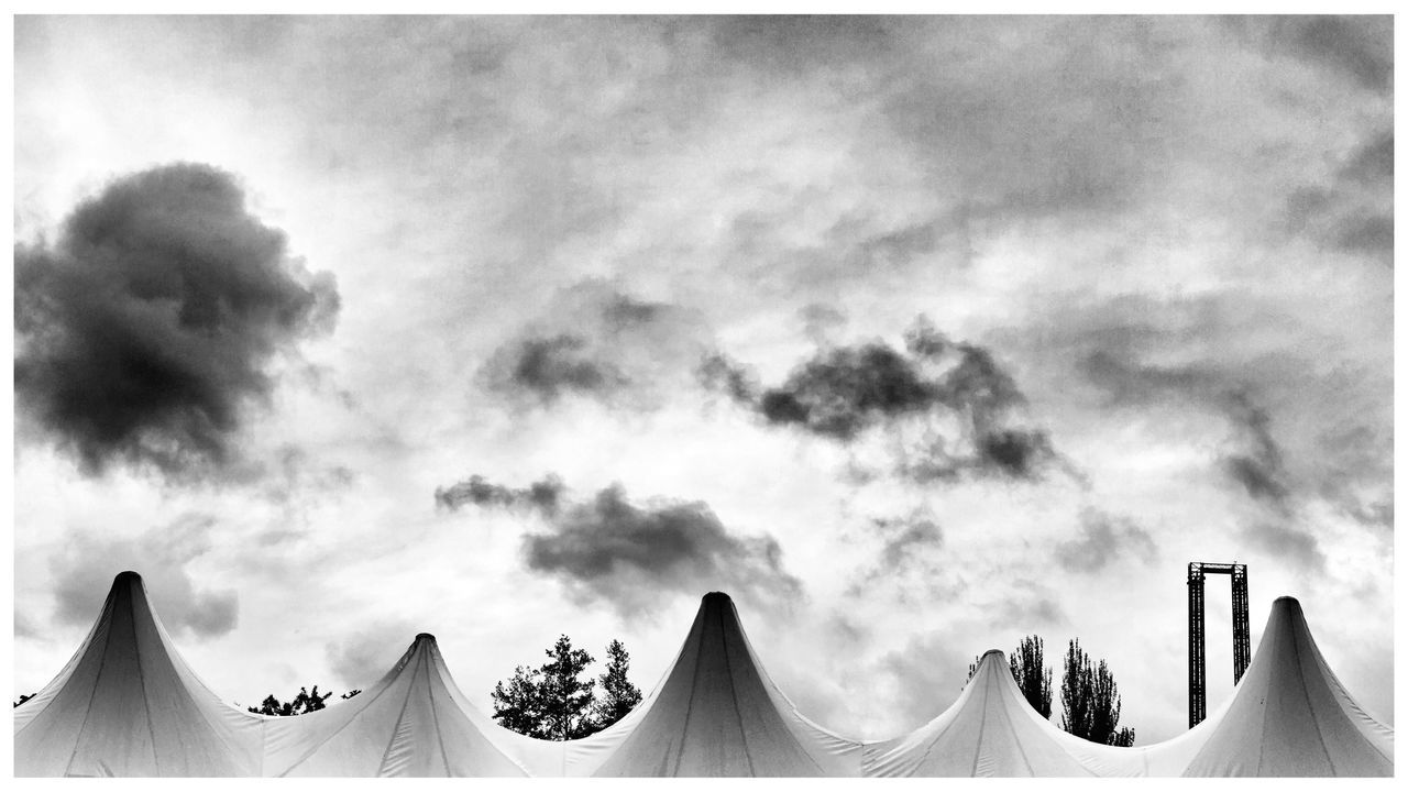 sky, low angle view, cloud - sky, cloudy, cloud, auto post production filter, nature, high section, in a row, transfer print, beauty in nature, outdoors, no people, day, roof, built structure, panoramic, overcast, architecture, scenics