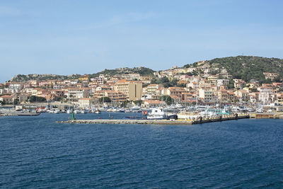 View of townscape by sea against sky