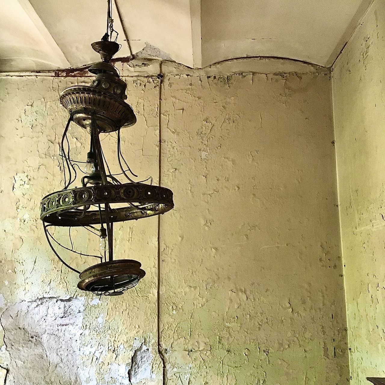LOW ANGLE VIEW OF ELECTRIC LAMP ON WALL IN OLD BUILDING