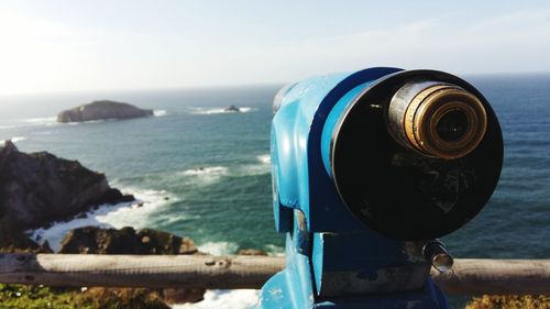 Close-up of coin operated binoculars at observation point against sky