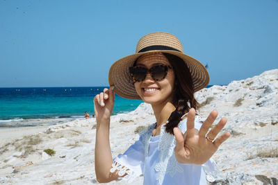 Portrait of young asian woman sitting on beach