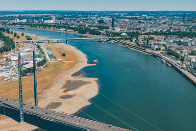 High angle view of bridge over river by buildings in city