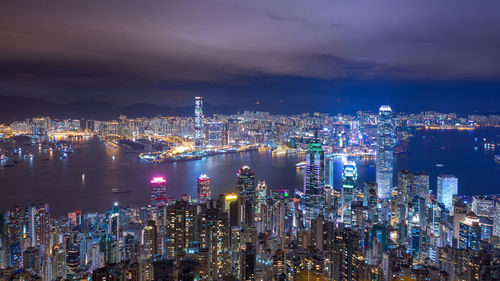 High angle view of illuminated city against sky at night