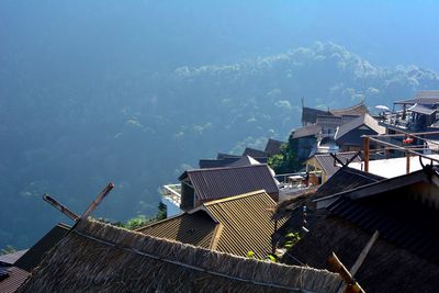 High angle view of buildings by sea against sky