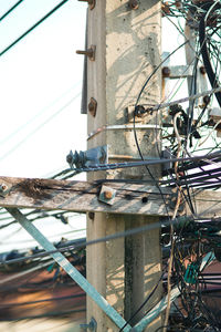 Low angle view of electricity pylon against sky