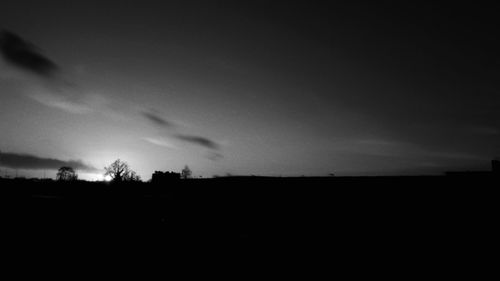 Silhouette landscape against sky during sunset