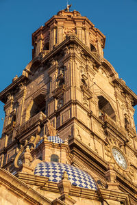 Low angle view of historic building against clear blue sky