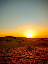 Scenic view of desert against sky during sunset