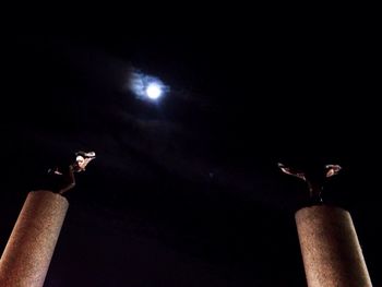 Low angle view of lamp post at night