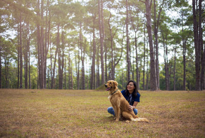 Rear view of people with dog in forest