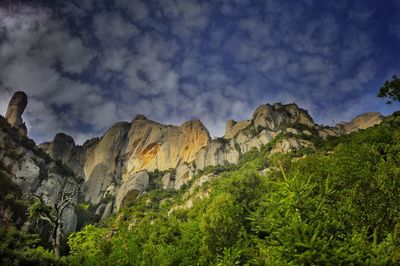 Scenic view of mountains against cloudy sky