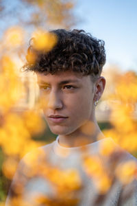 Portrait of young man looking away outdoors