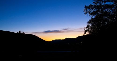 Silhouette trees against sky during sunset