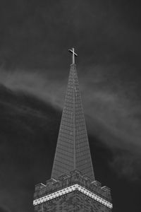 Low angle view of tower against cloudy sky