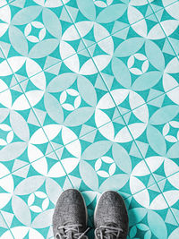 Low section of woman standing on tiled floor