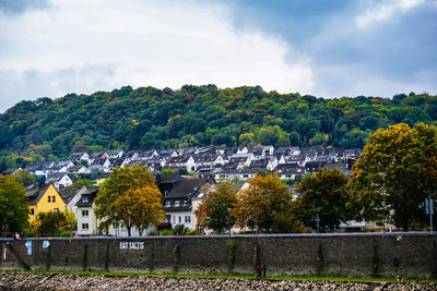 Buildings in town against cloudy sky