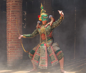 Full length of man wearing traditional clothing while dancing