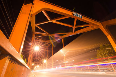 Low angle view of illuminated bridge at night