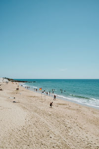 Scenic view of beach against clear blue sky