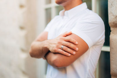 Midsection of man standing by wall