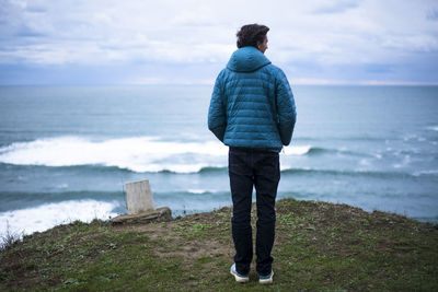 Rear view of man looking at sea shore