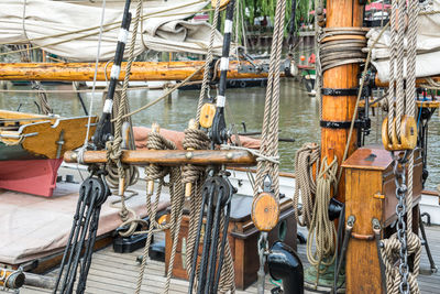 Sailboats moored at harbor