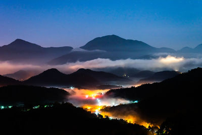 Scenic view of silhouette mountains against sky at sunset