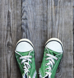 Close-up of canvas shoes on hardwood floor