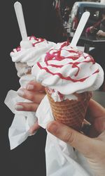 Close-up of woman holding ice cream cone