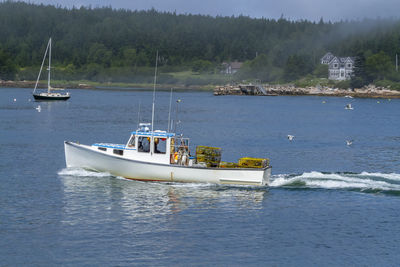 Boats in sea against sky