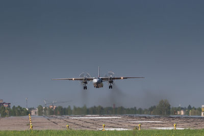 Soviet civil propeller airliner. russian turboprop old aircraft taking off with smoke