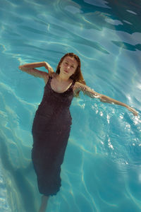 High angle portrait of young woman in swimming pool