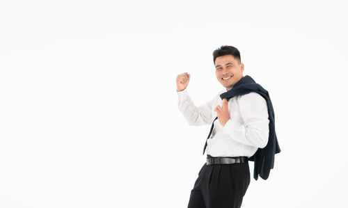 Portrait of smiling man standing against white background