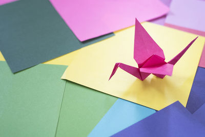 High angle view of origami on colorful papers