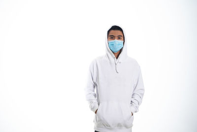 Portrait of man standing against white background