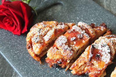 High angle view of rose on cutting board