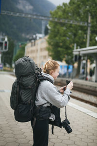 Woman using cell phone on train station