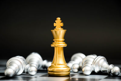 Close-up of chess pieces against black background