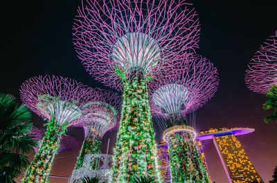 Low angle view of illuminated fireworks against sky at night