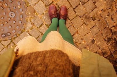 Close-up of woman standing on tiled floor