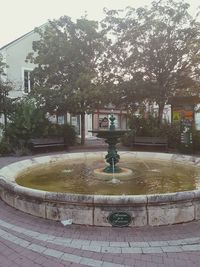 View of fountain in park during rainy season