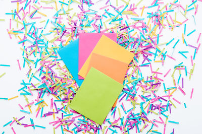 High angle view of multi colored pencils on white background