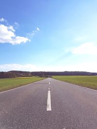 Road by landscape against sky