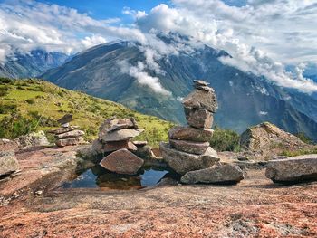 Stack of rocks on mountain against sky