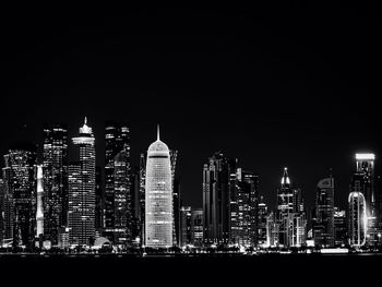 View of skyscrapers lit up at night