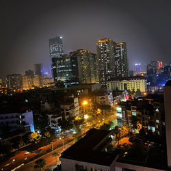 High angle view of illuminated buildings in city at night