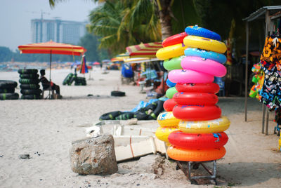 Colorful inflatable rings stack at beach