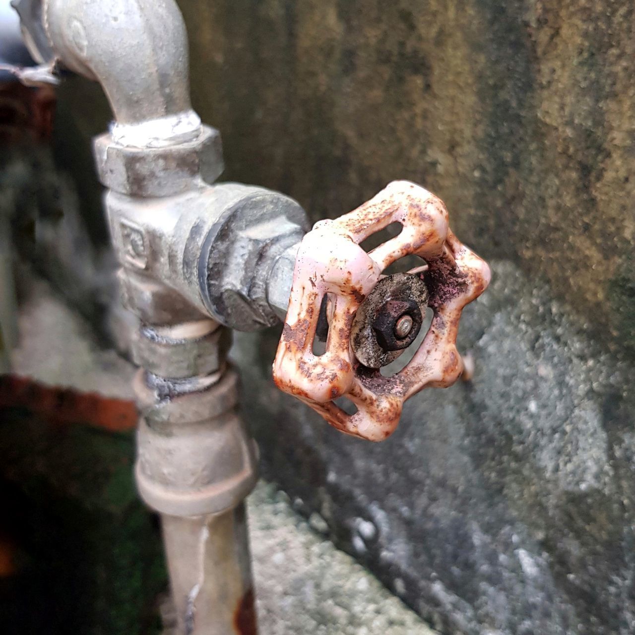 HIGH ANGLE VIEW OF OLD FAUCET